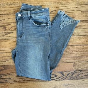 Light gray jeans, ripped hem